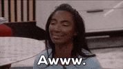 Reality TV gif. Taylor Hale on Big Brother smiles and glances up. Text, "aww."