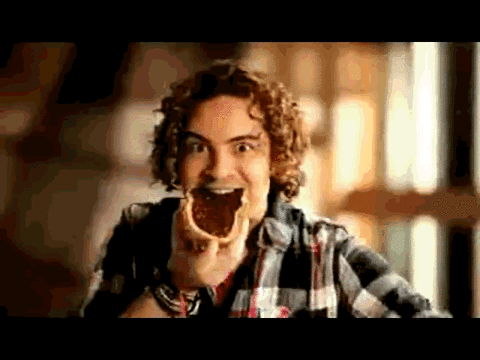 Celebrity gif. David Bisbal revels in taking a bite from a piece of toast, squeezing his eyes shut and leaning his head back in bliss.
