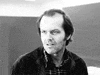 Movie gif. In black and white, Jack Nicholson as Jack Torrance in The Shining smiles with complete madness.