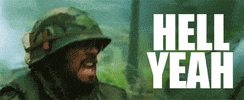 Movie gif. Robert Downey Jr. as Kirk Lazarus from Tropic Thunder wears an army uniform and helmet as he yells: Text, "Hell yeah."