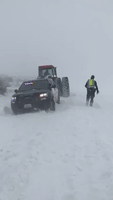 Tractor Frees Police Car Trapped in Washington Blizzard