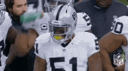 Sports gif. Oakland Raider Bruce Irvin rhythmically bobs his head, nodding in approval.