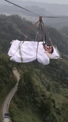 Sleep Tight! Adventurers Cozy Up in a Bed Hanging in Midair at Chinese Theme Park