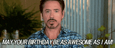 Video gif. Robert Downey Jr. points at us with a sassy eyebrow raise, saying, "Happy birthday be as awesome as I am."