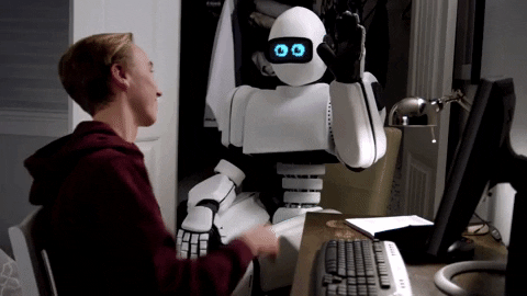 News Sebrae - Edição 50 - GIF de menino batendo na mão de um robô. O menino é loiro e está com um moletom vermelho escuro. O robô é branco com olhos digitais azuis.