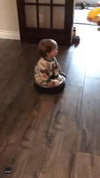 Toddler Hitches a Ride on a Roomba