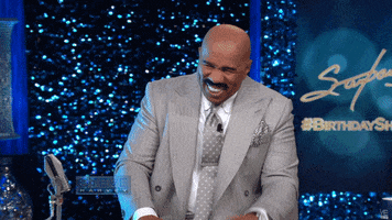 Celebrity gif. Steve Harvey dies of laughter in his chair as he cracks up and rocks back.
