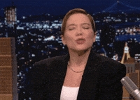 Tonight show gif. Lea Seydoux clasps her hands together and holds them up to her chest. She looks up with pursed lips and closed eyes like she’s begging for a kiss.