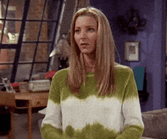 Friends gif. Lisa Kudrow as Phoebe Buffay puts both hands to her chest and smiles in relief.