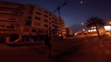 Man Fearlessly Hangs From Crane Above Moroccan Capital