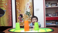Boy Stacks Glowing Plastic Cups Incredibly Fast