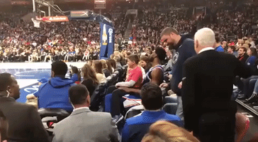 In the Lap of the Gods... Joel Embiid Lets Young Fan Sit on His Knee During Sixers Win