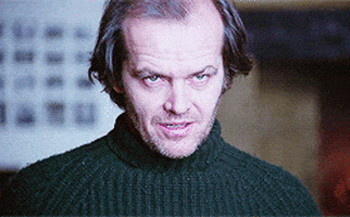 Movie gif. We zoom in on a terrifying Jack Nicholson's face as he gives a death stare while playing Jack Torrance in The Shining.