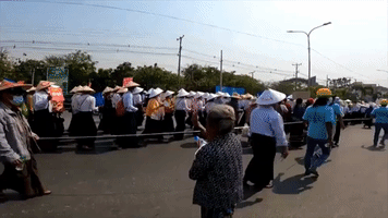 Elderly Woman Hands Out Snacks From Sidelines of Mandalay Protest