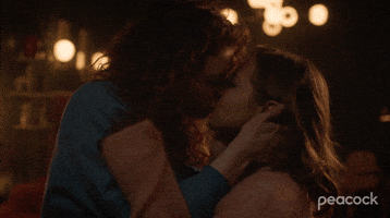 TV gif. From Vampire Academy, Rhian Blundell as Meredith holds Mia McKenna-Bruce as Mia's head in her hands, sharing a sultry kiss.