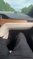 Look, No Hands! Man Cruises Down Highway in Self-Driving Tesla