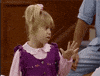 TV gif. One of the Olsen twins as Michelle from Full House holds up her hand like whatever and sassily turns away while rolling her eyes.