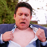 Video gif. A man wearing a suit has his shirt ripped open and he looks frightened as his heart beats so hard that it nearly jumps out of his chest and it makes an imprint on chest every time it pumps.
