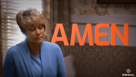 Movie gif. A woman bows her head and lifts a hand as she says, "Amen."