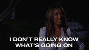 Reality TV gif. The Bachelorette contestant Tayshia Adams sheepishly says with a big smile on her face, “I don’t really know what’s going on.”
