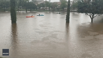 Kids Have 'a Blast' Kayaking on Flooded Arizona Street