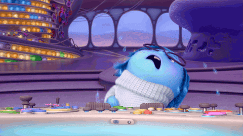 Movie gif. Sadness from Inside Out drops her head as if in despair as tear drops fly from her blue face. 