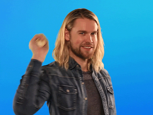 Celebrity gif. Chord Overstreet smiles and thrusts a mannequin hand toward us for a high five.