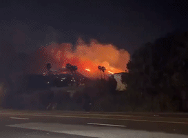 Emerald Fire Fueled by Santa Ana Winds Burns in Southern California