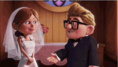 Disney gif. Carl and Ellie from Up are young and getting married. They've just said yes at the alter and Carl opens his arms to Ellie for the kiss. Ellie launches herself at him instead, giving him a big smooch that he looks happy and shocked at.