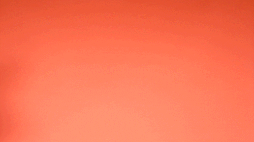 Video gif. Against a light orange background, three people cha-cha across the screen, the words "Teamwork makes the dream work" appearing as they walk.