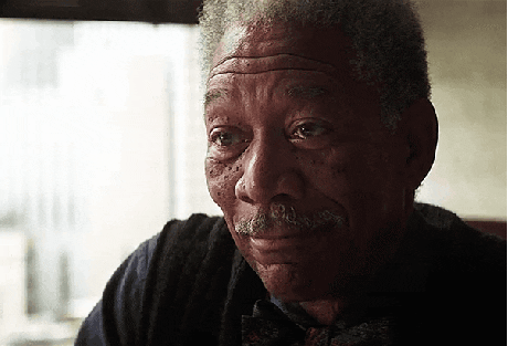 Celebrity gif. Actor Morgan Freeman as Lucius Fox in Batman The Dark Knight cocks his head to the side with an amused grin and cheerfully says "Good luck!" Text, "Good luck!"