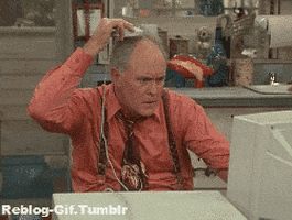 TV gif. Looking perplexed, John Lithgow as Dick on 3rd Rock from the Sun sits in front of a computer, rolling a computer mouse on his head.