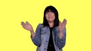 Celebrity gif. Emily Warren shakes her head, clapping against a bright yellow background.