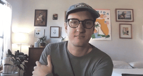 Celebrity gif. Tyler Menzel, in a home environment, appears to be listening, nodding slightly and then saying "awesome," which appears as text.