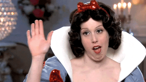 SNL gif. Vanessa Bayer as Snow White, with a subtly confident facial expression, holds her hand up for high-fives with a bunch of smaller dwarves' hands.