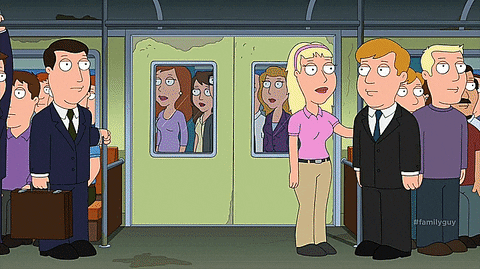Family Guy gif. As a crowd of people boards a subway train, Peter shoves past them, holding multiple shopping bags, forcing several passengers to move as he takes a seat.