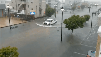 Truck Drives Through Flooded New Jersey Street After Storm