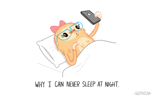 Kawaii gif. A cute sloth wearing a pink bow in her hair and big blue glasses lies in bed, playing on her phone and laughing. Text, “Why I can never sleep at night.”