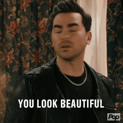 Schitt's Creek gif. Dan Levy as David Rose shakes his head in surprise and says "You look beautiful!'