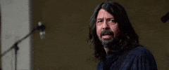 Celebrity gif. Dave Grohl sees something and turns away while rolling his eyes heavily.