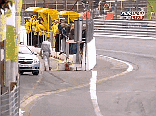 Video gif. Safety car drives out of a pit stop during a race and accidently collides with a racecar from behind them, resulting in the racecar losing a wheel and hitting the wall. We then see the same scene from the perspective of a camera on the racecar just behind the crash.