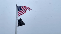 US Flag Waves as Snow Falls on Ohio's Lake Erie Coastline