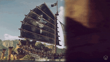Video game gif. From Skull and Bones, a pirate ship sails quickly through the ocean passing stone columns and its sail whips in the wind.