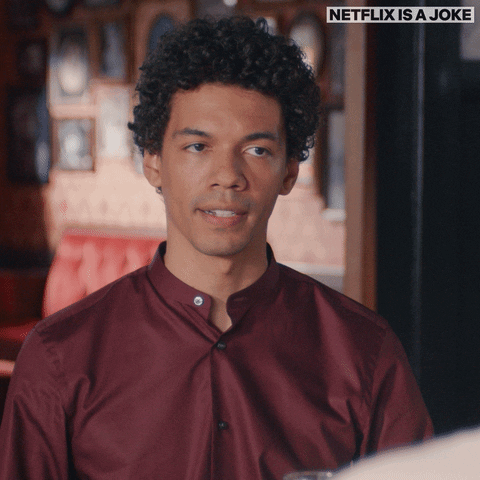 TV gif. Jonathan Braylock in The Astronomy Club. He looks at someone before rolling his eyes and upturning his lips, making a funny eye-roll-gopher-teeth face. 