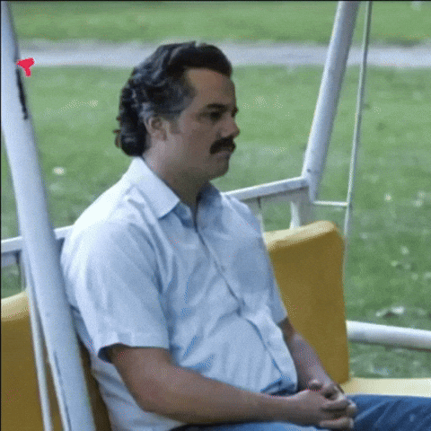 Meme gif. Sad Pablo Escobar, Wagner Moura as Pablo Escobar on Narcos, sitting on a suburban swing, hands in his lap, downcast.