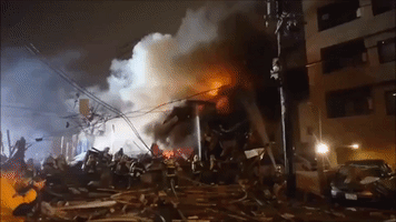 Firefighters Spray Water on Flaming Wreckage Following Sapporo Explosion