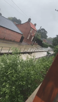 Water Cascades Down Streets of English Town After Month's Worth of Rain Falls in a Day