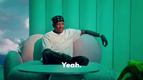 TV gif. YG as a guest on the Demi Lovato show, seated with his arm cradling the back of a bubbly couch, smiling and nodding while saying, "yeah."