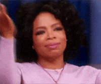 Video gif. Oprah Winfrey claps her hands together, folded under her chin, as she closes her eyes and looks grateful. 