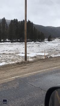 Debris and Chunks of Ice Swept Along by Rushing Montana River